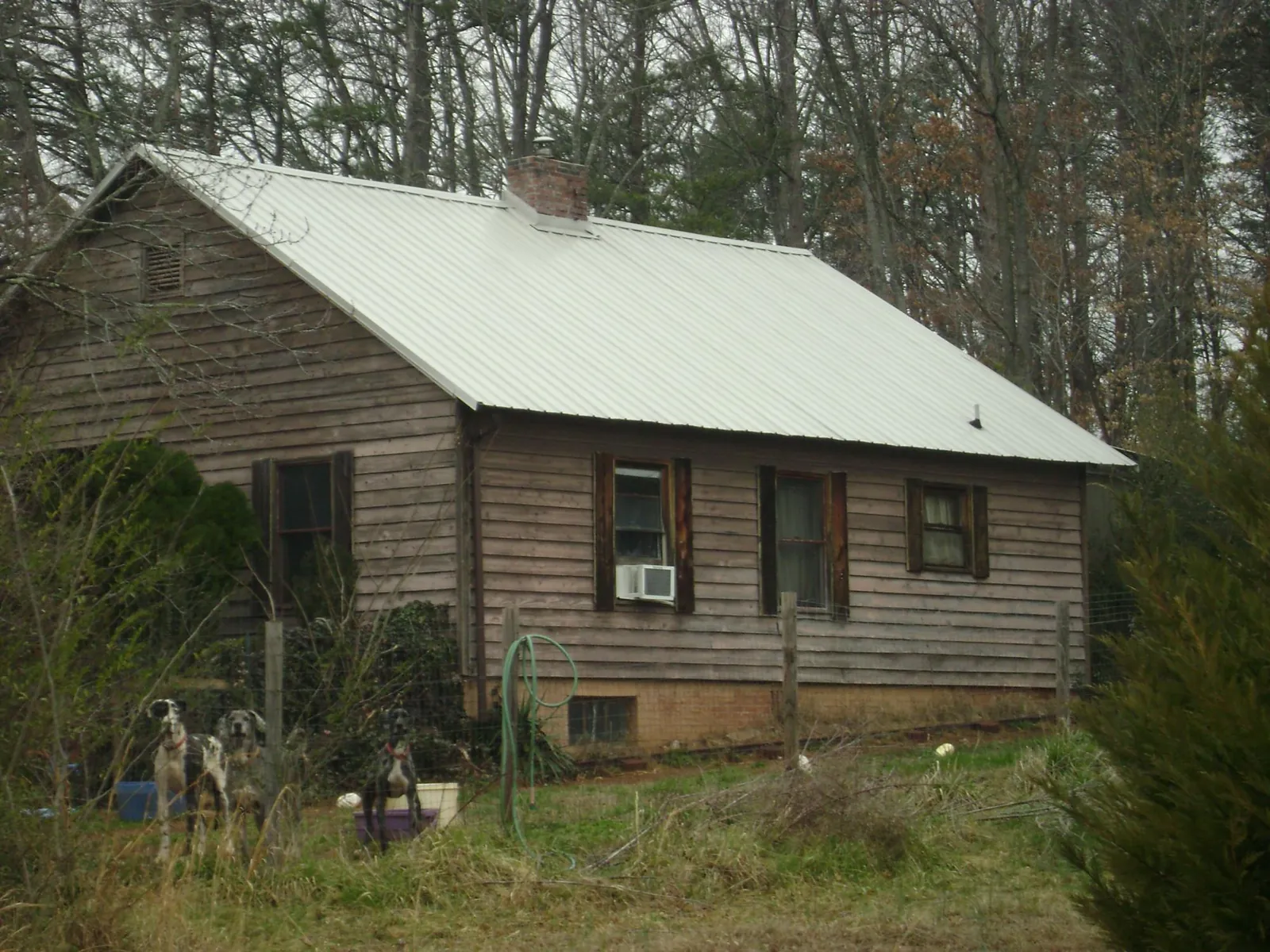 White metal roof on an old wood sided farmhouse, from a Metal Roof Installation job in Dunlap