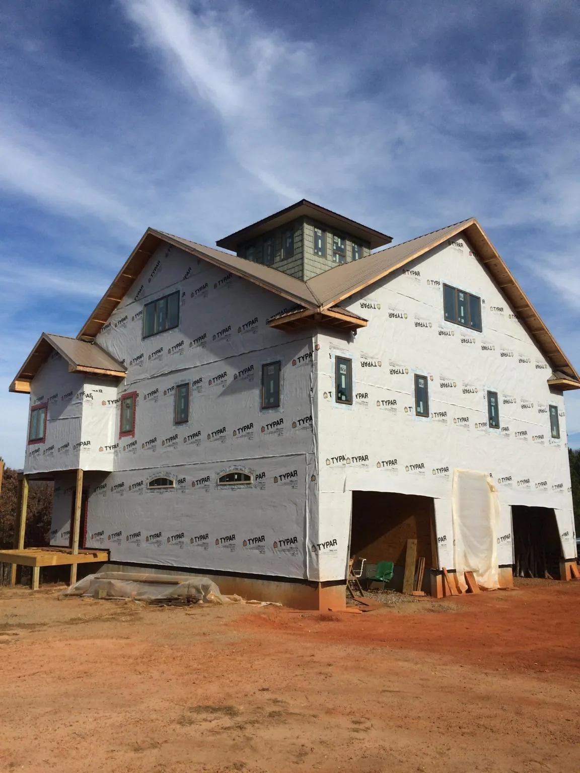New two story house under construction with a cupola and gabled roofs in Dunlap